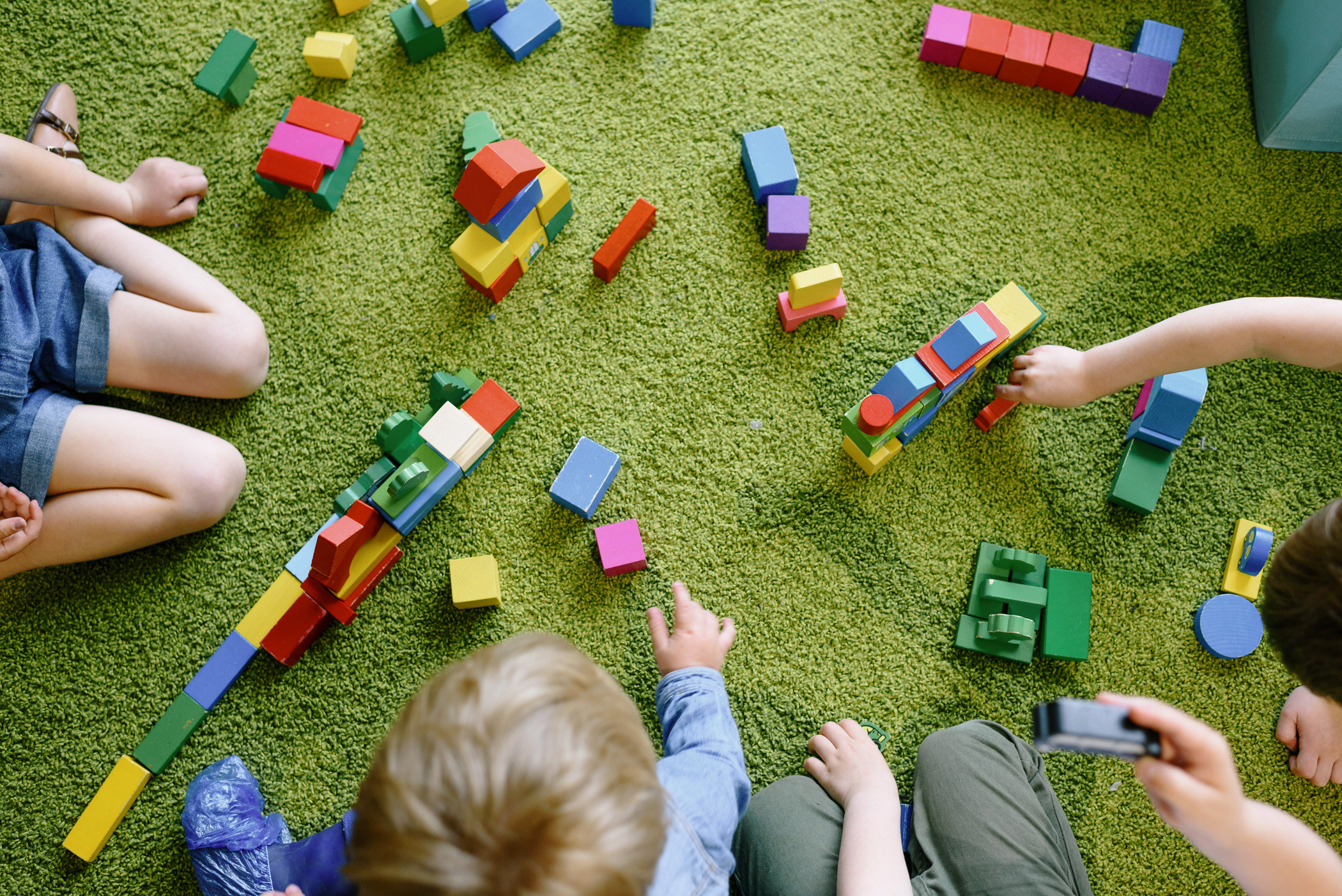 Children Playing with Colorful Wooden Blocks